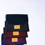 a group of four different colored ties sitting on top of each other