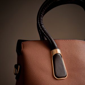 A brown and black handbag is on display.